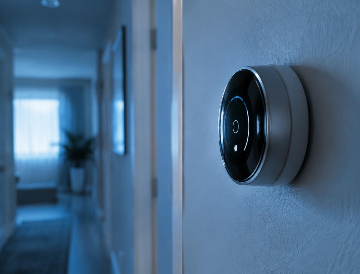 Smart thermostat on a hallway wall
