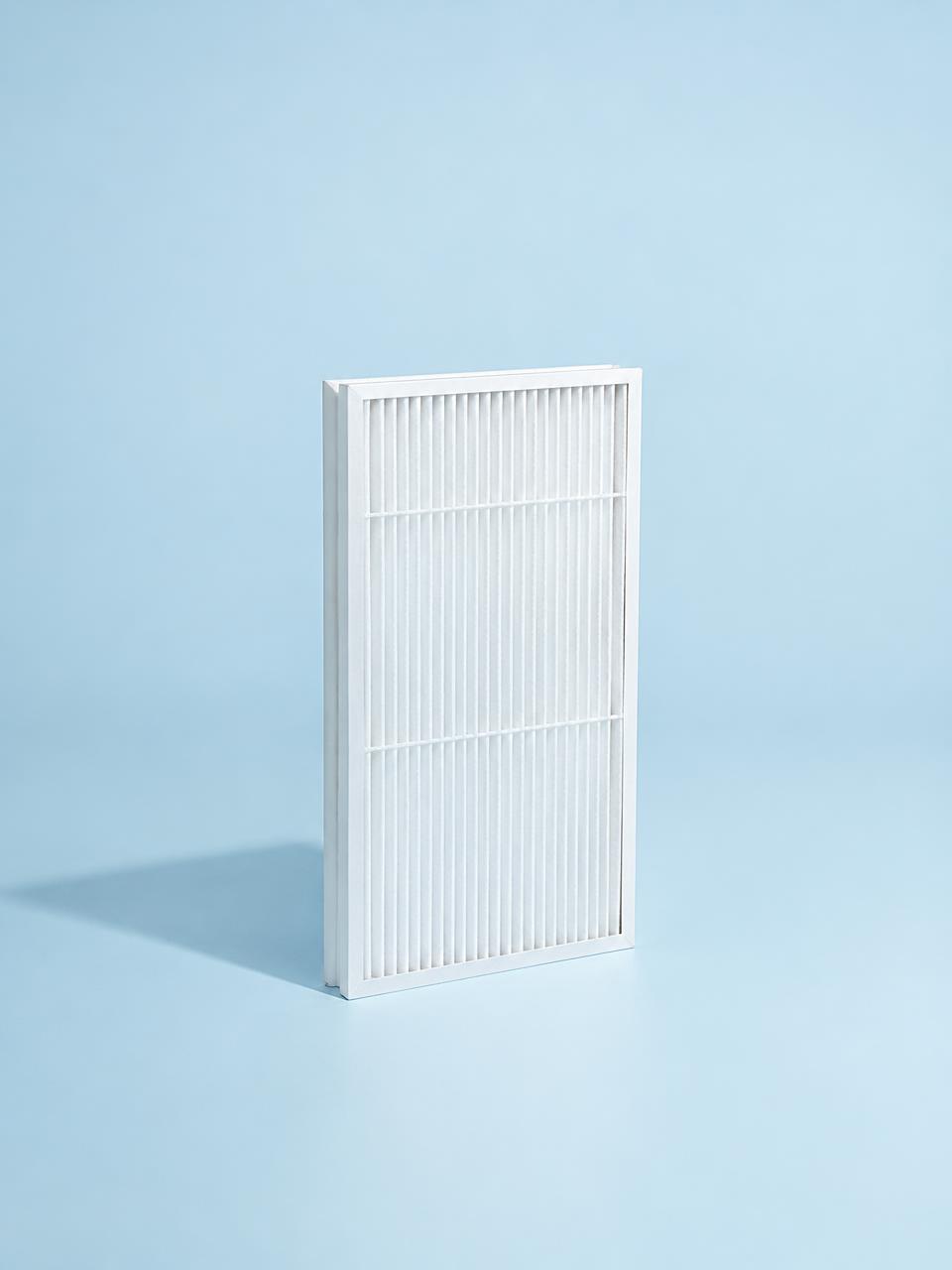 Fresh air filter standing on a pale blue backdrop